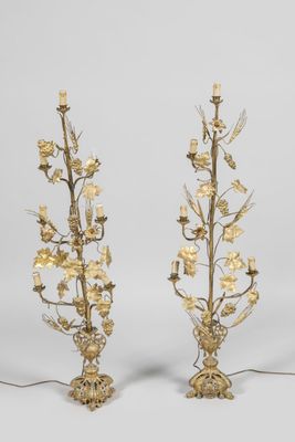 a pair of brass and glass table lamps with flowers and leaves