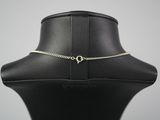 a black mannequin with a gold chain on it