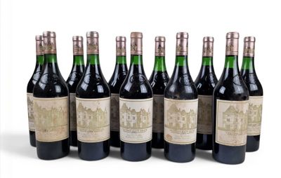 six bottles of wine are lined up in a row on a white surface