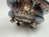 a silver bowl that has a handle on it