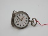 a silver pocket watch with roman numerals on it