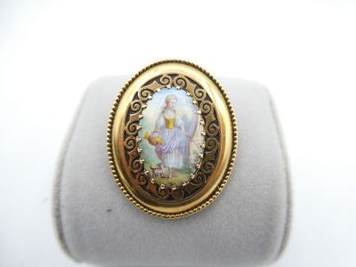 a close up of a ring with a picture of a woman on it