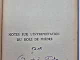 un livre ouvert, sur lequel figure un titre écrit à la main, posé sur une table