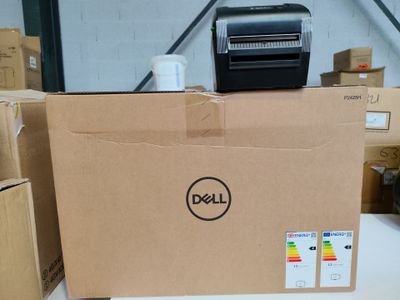 a dell printer sitting on top of a box in a warehouse