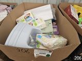 a cardboard box filled with diapers and other items