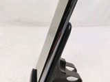 a cell phone that is sitting on top of a stand