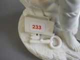 a statue of a man holding a key and a sign