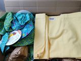 a cardboard box filled with clothes and other items