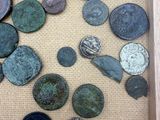 a lot of coins in a wooden frame on a table