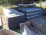 a pile of steel beams sitting in a yard