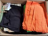 a box full of clothes that is sitting on the floor