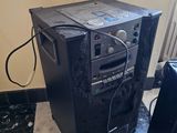 a small black machine sitting on the floor next to a black chair