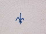 a picture of a blue and white plate with a flower on it