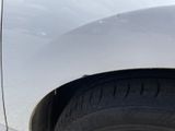 a close up of a car ' s tire on the side of the road