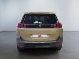 the rear end of a beige car with the number v2 on it