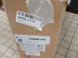 a cardboard box with a sticker on it sitting on a tiled floor