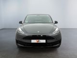 the front of a black tesla model s parked in a white room
