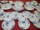 a lot of plates and bowls on the table