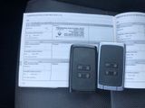two cell phones sitting on top of a car dashboard