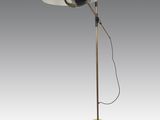 a yellow floor lamp with a black shade on top of it