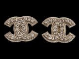 a pair of chanel earrings with diamonds