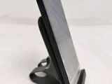 a cell phone that is on a stand on a table