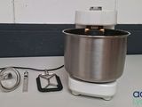 a mixer on the counter with a wire attached to it