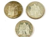 three different types of coins are shown on a white surface