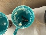 three cups and two spoons on a table
