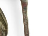 two spoons that are sitting next to each other