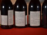 four bottles of wine are lined up on a table