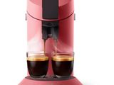 une image représentant une cafetière rose avec deux tasses de café
