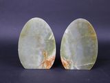 a pair of green jade bookends on a black background