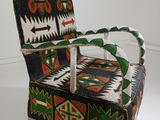 a colorful chair that is on display in a room