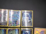 the pokemon cards are lined up on a black surface