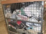 a metal cart with a bunch of clothes in it
