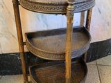 a three tiered shelf in a room with marble flooring