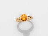 a gold ring with an oval citrine stone in the center