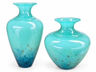 two vases sitting next to each other on a white surface