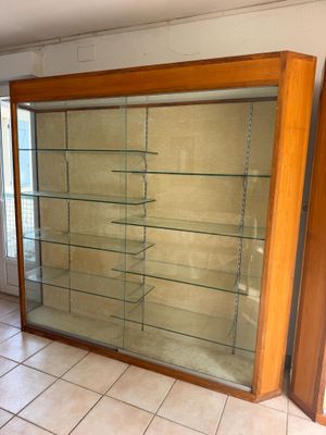 a glass display case in the corner of a room
