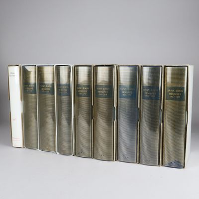 six books in a row on a white surface