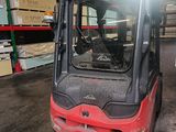 a red forklift truck parked in a warehouse