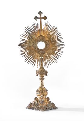 une image représentant un calice doré surmonté d'une croix