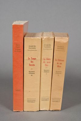 three books are stacked on top of each other on a gray surface