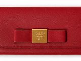 a red wallet with a gold bow on the front