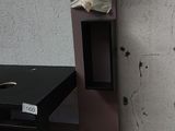 a desk with a computer on top of it in a room