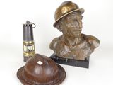 a statue of a man with a hat next to a lighter