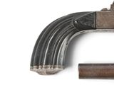 a gun that is sitting on top of a piece of metal