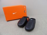 a pair of shoes that are next to an orange box