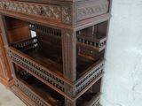 a tall wooden cabinet that has many drawers on it